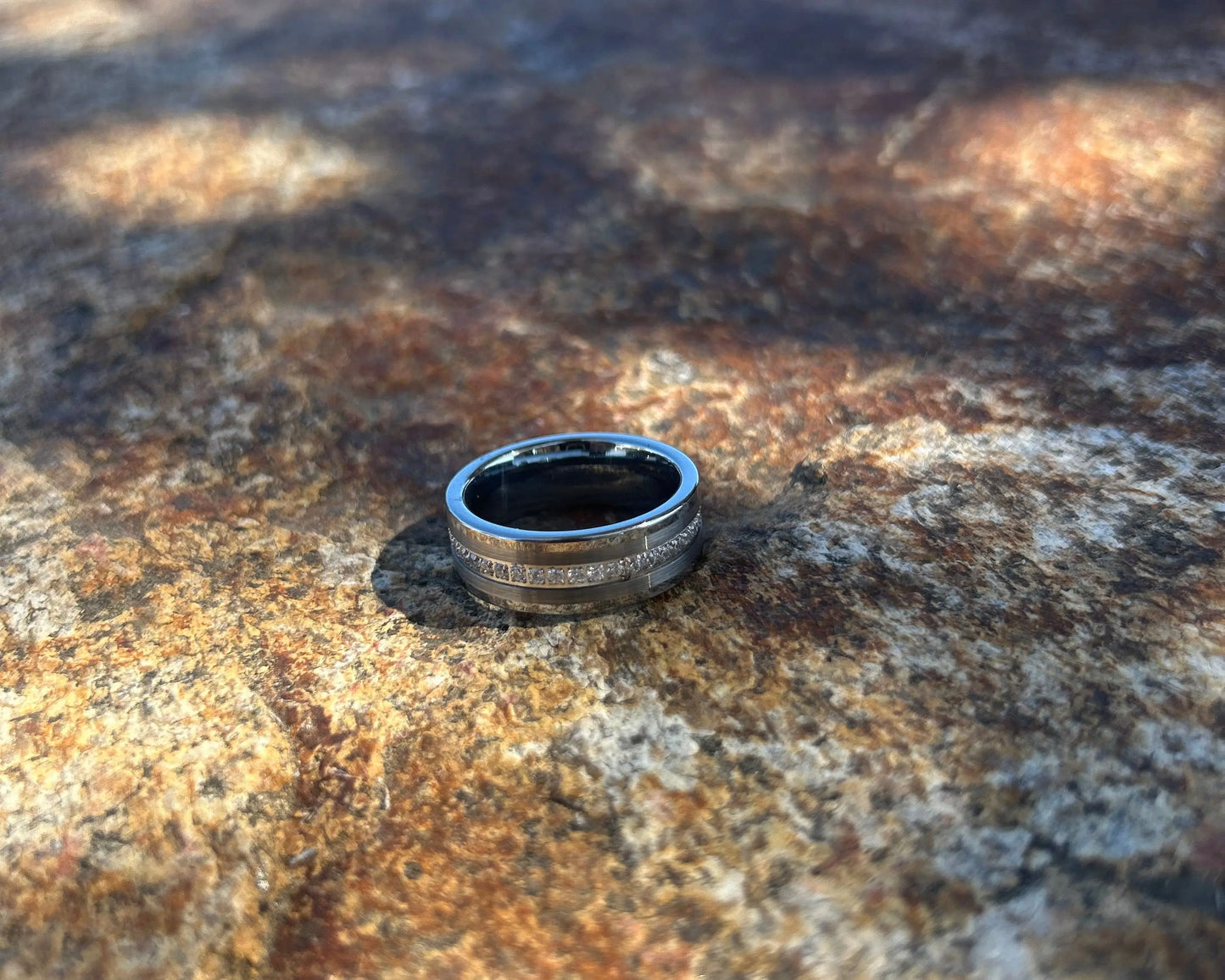 Silver ring on a textured stone surface