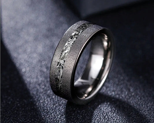 Cosmos ring with meteorite inlay on dark surface