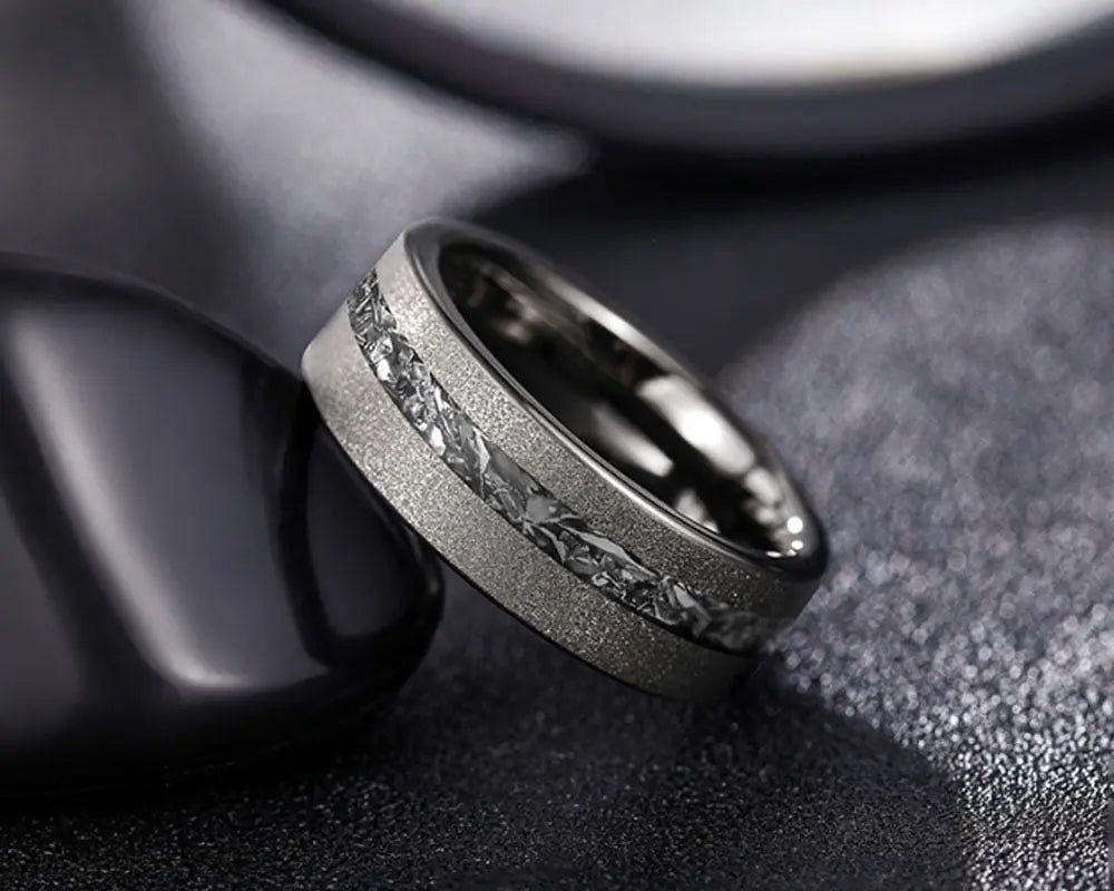 Cosmos ring with meteorite inlay on dark surface