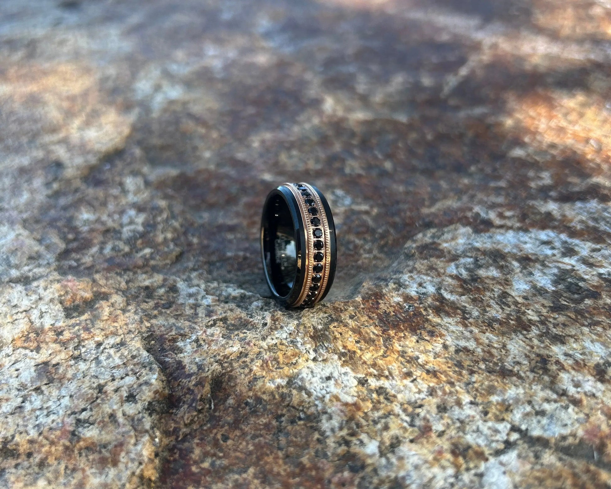black and gold ring with black CZ's on a textured stone
