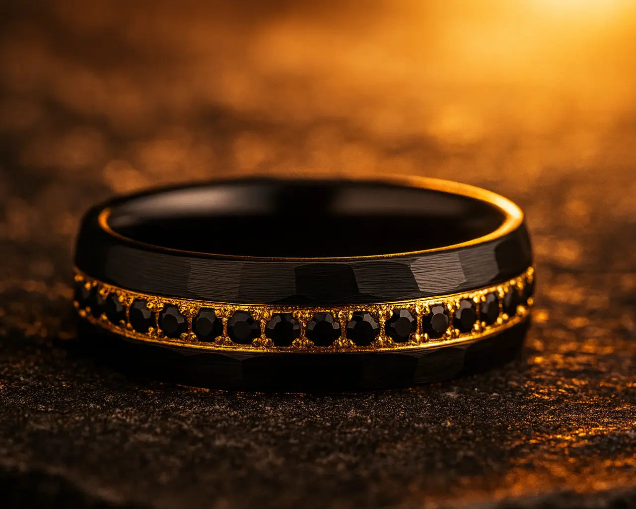 Black ring with gold accents on a textured brown surface