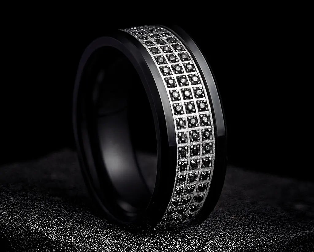 Black ring with embedded diamonds on a dark background