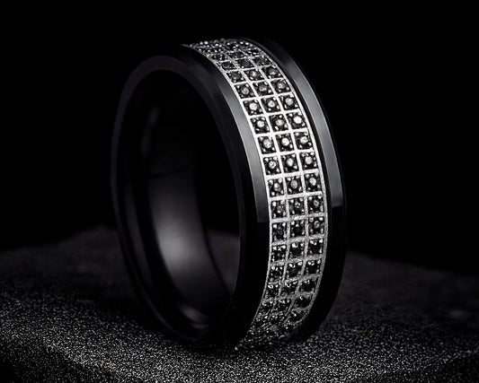 Black ring with embedded diamonds on a dark background