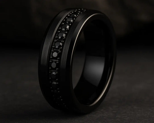 Black ring with embedded stones on a dark background