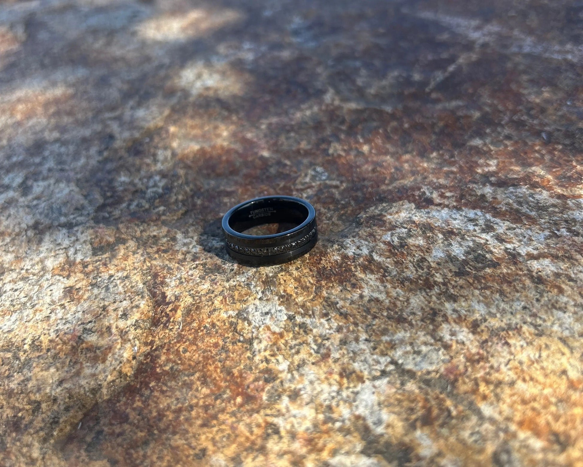 Black ring with black CZ's on a textured rock