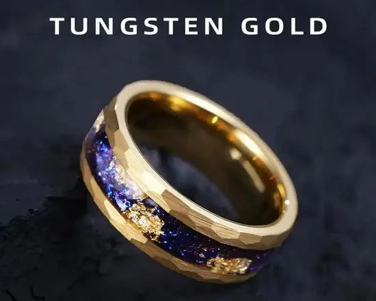 Gold ring with blue & gold stardust inlay on dark surface